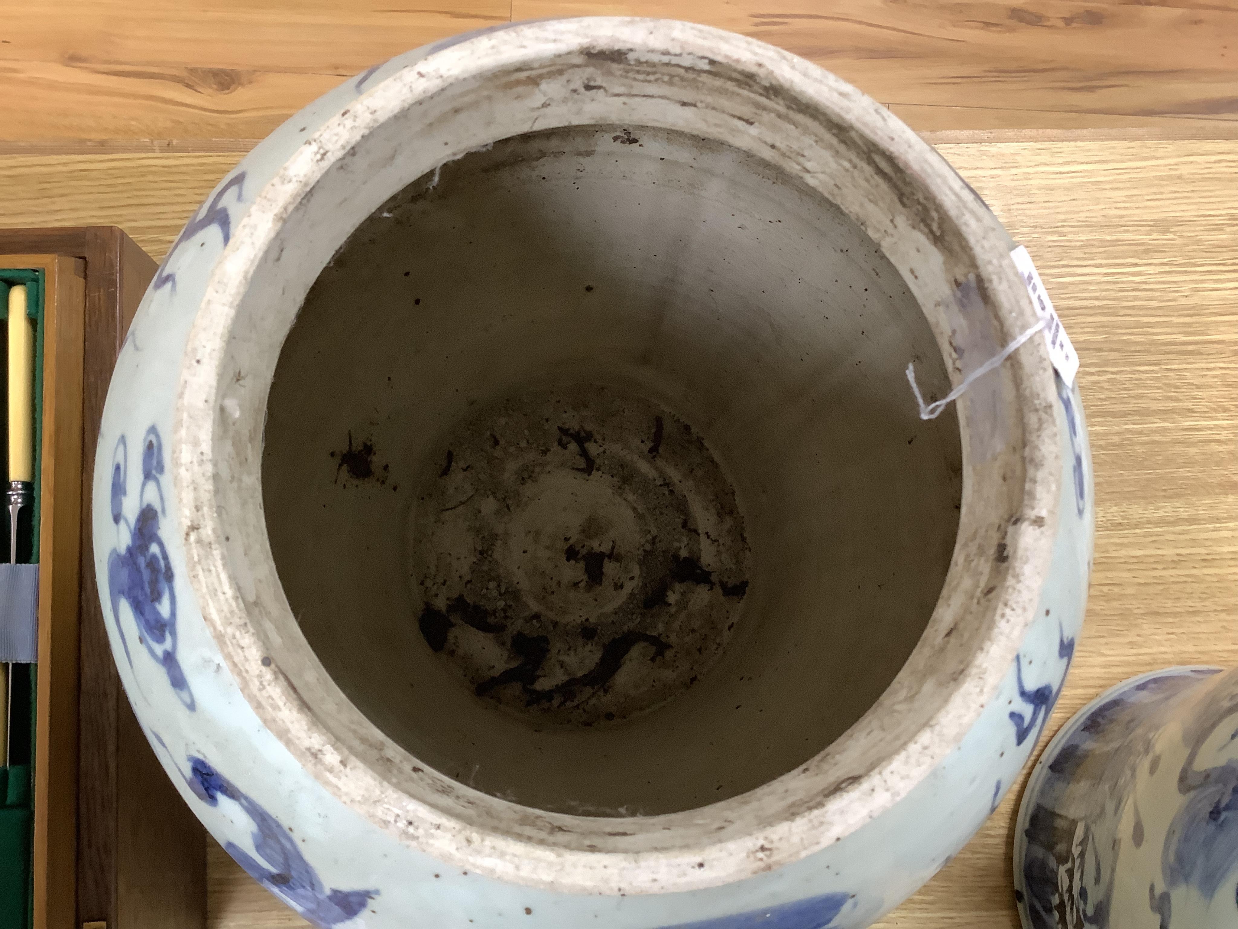 A pair of large Chinese blue and white ginger jars and covers, 54cm high. Condition - fair to good